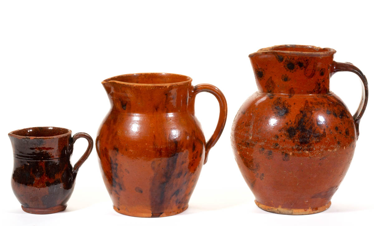AMERICAN DECORATED EARTHENWARE / REDWARE PITCHERS, LOT OF THREE
