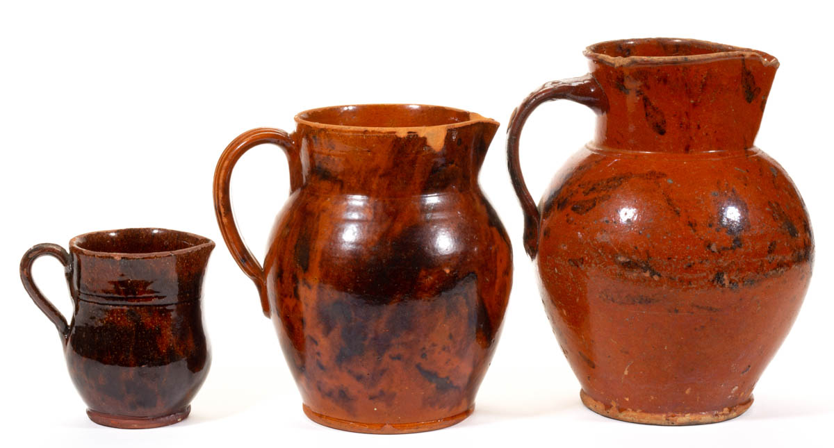 AMERICAN DECORATED EARTHENWARE / REDWARE PITCHERS, LOT OF THREE