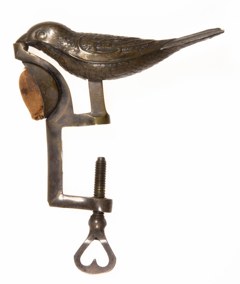 A. GEROULD STAMPED AND CAST-METAL FIGURAL SEWING BIRD CLAMP WITH PINCUSHION HOLDER