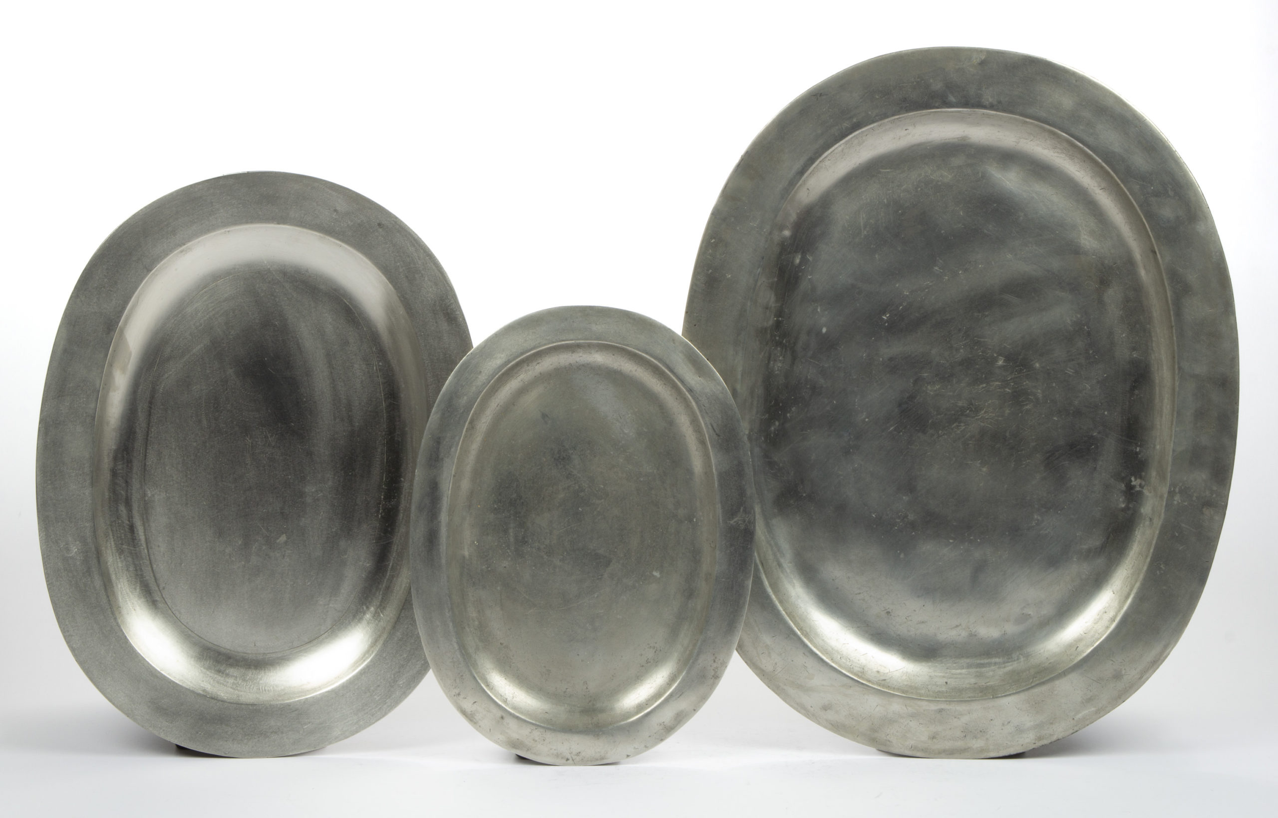 ASSORTED ENGLISH PEWTER PLATTERS, LOT OF THREE,