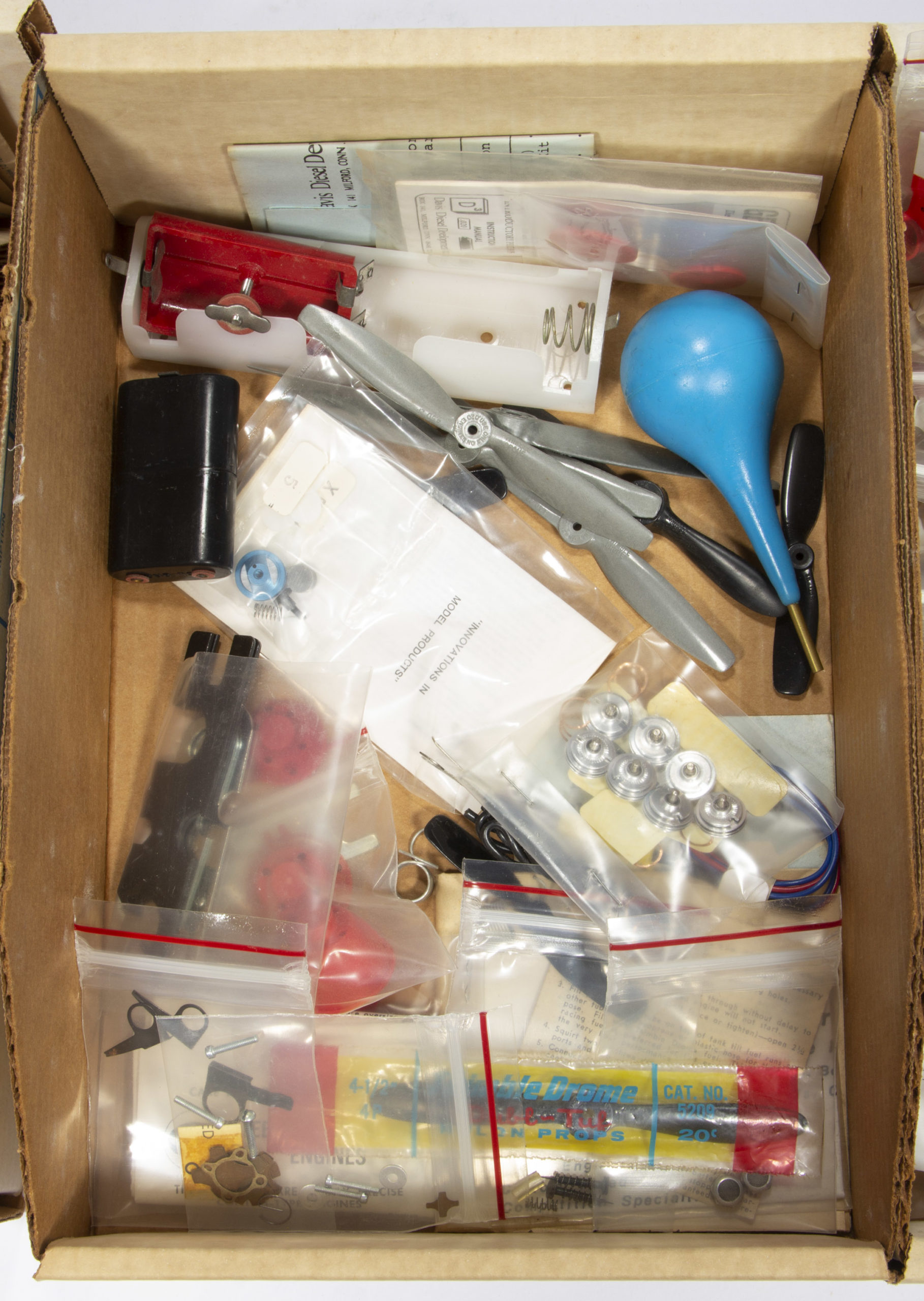 L. M. COX MANUFACTURING CO. MODEL AIRPLANE ENGINE PARTS AND RELATED ARTICLES, UNCOUNTED LOT,